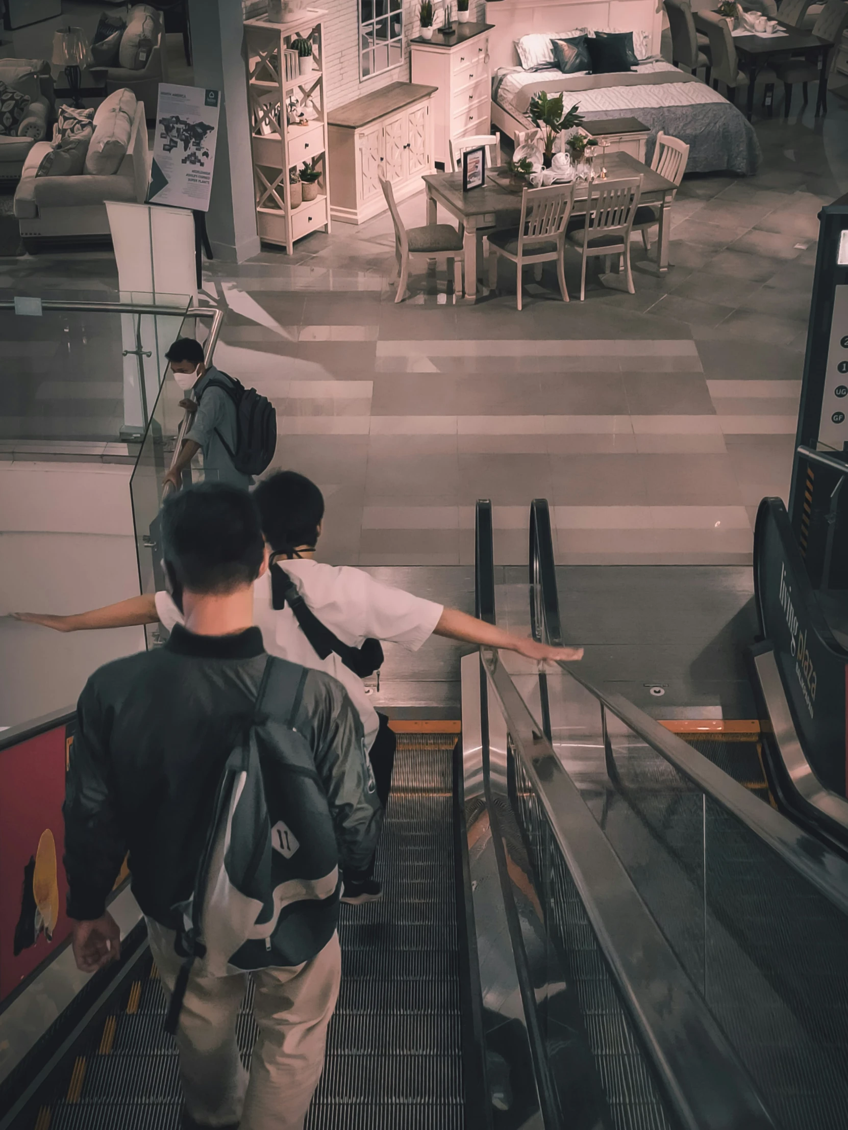 a man riding an escalator while holding onto his luggage