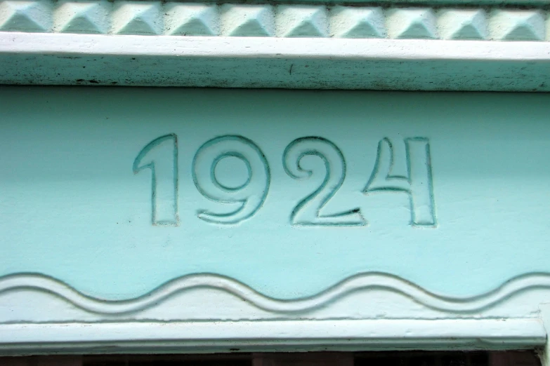 a close up of an old house's address number