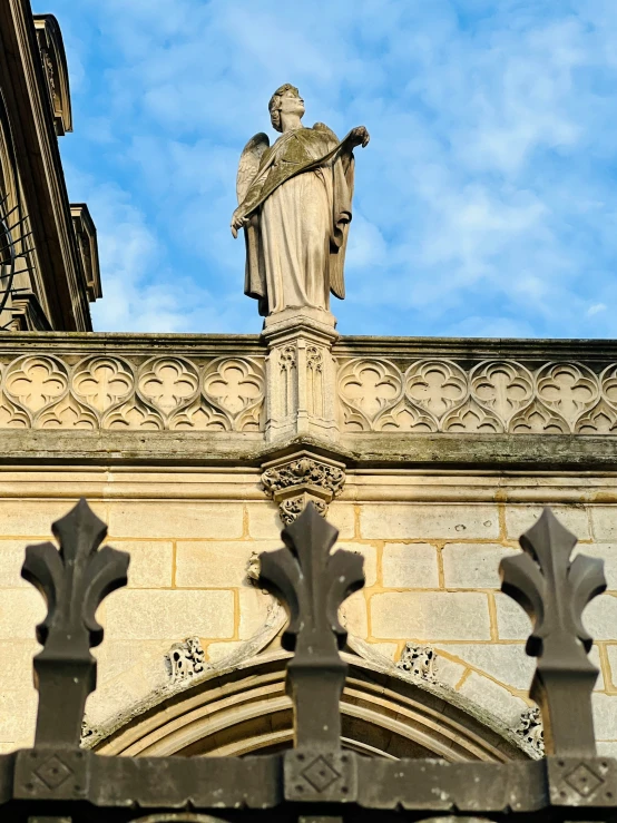 a statue on the top of a tall building