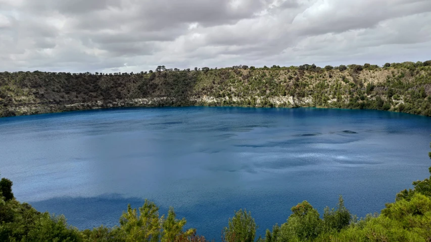 a blue lake surrounded by lots of trees