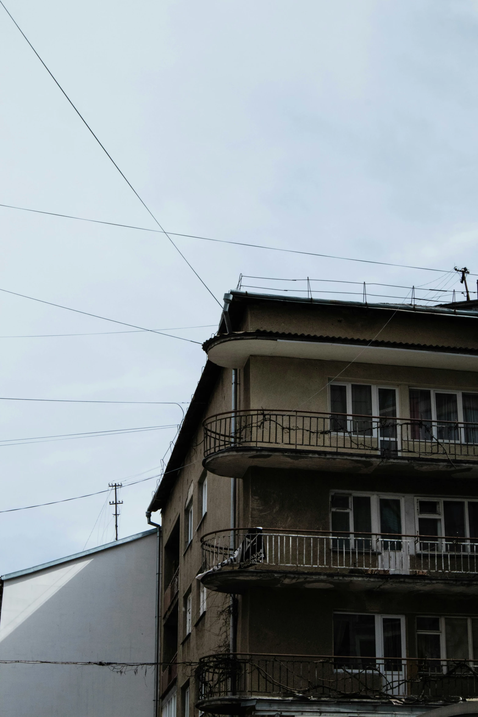 an apartment building with an iron fence and a clock