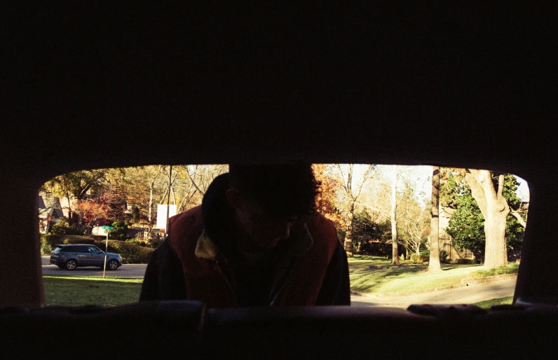 a person in a car that is looking out the window