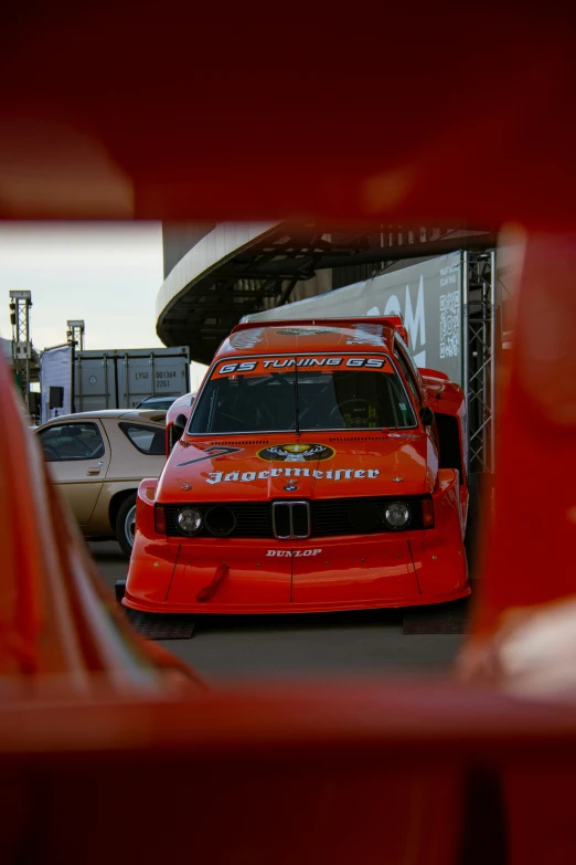 a small red car in the reflection of a mirror