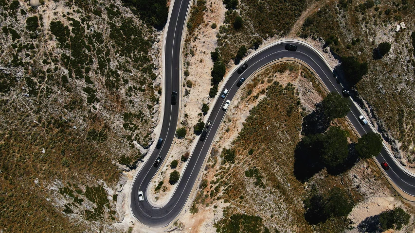 a road with three intersecting curves going through a landscaped area