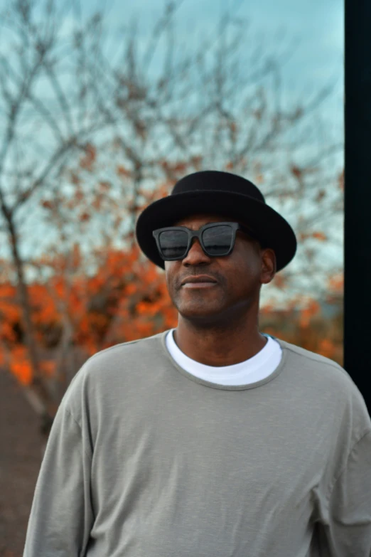 a close up of a person wearing glasses and a hat