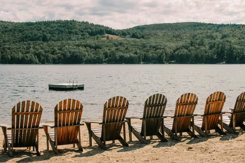 a row of chairs sitting in the sand