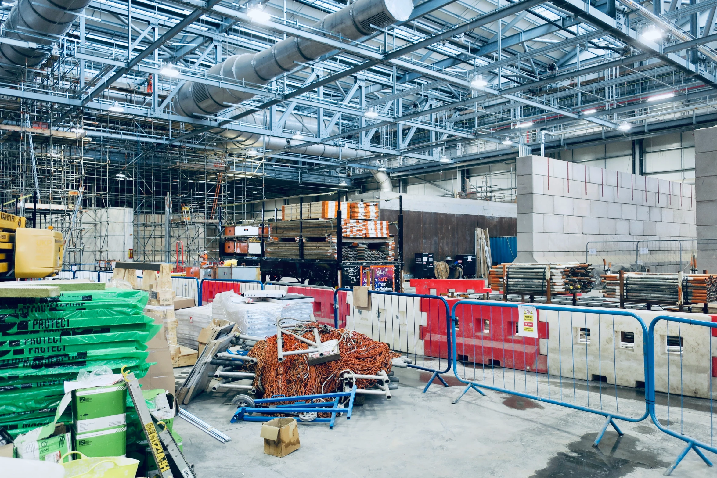 an indoor warehouse with a bunch of boxes and other items