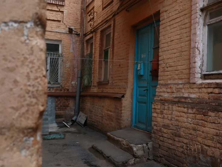 an old building with a blue door and windows