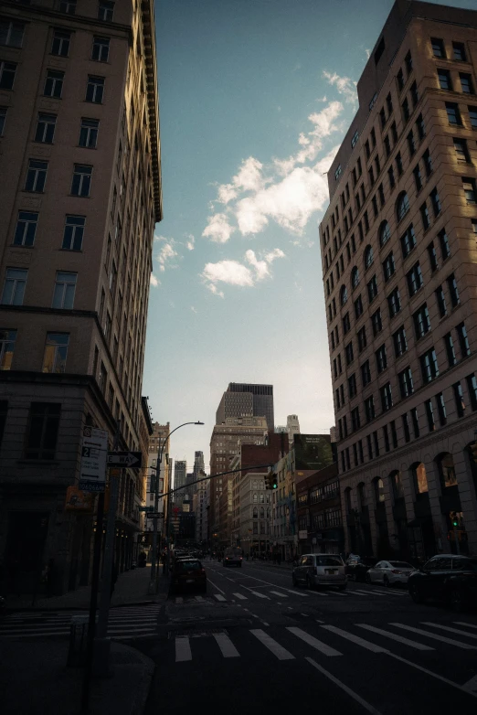 the view of two very tall buildings in an intersection