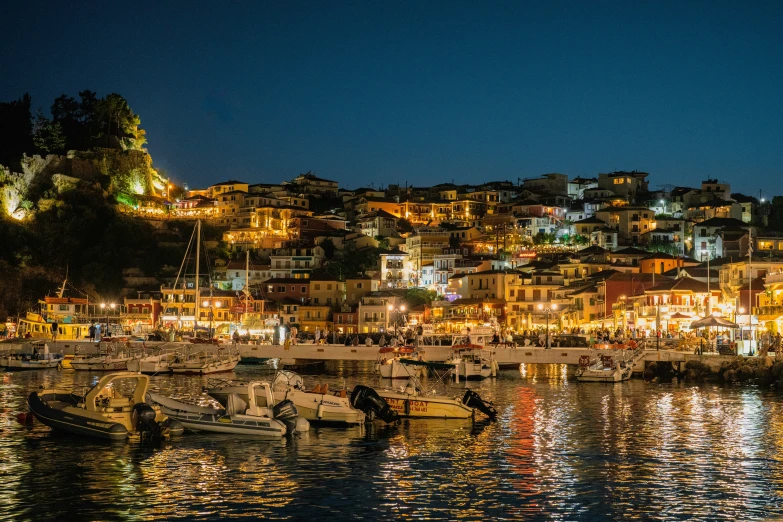 a city sits on top of a hillside overlooking the water