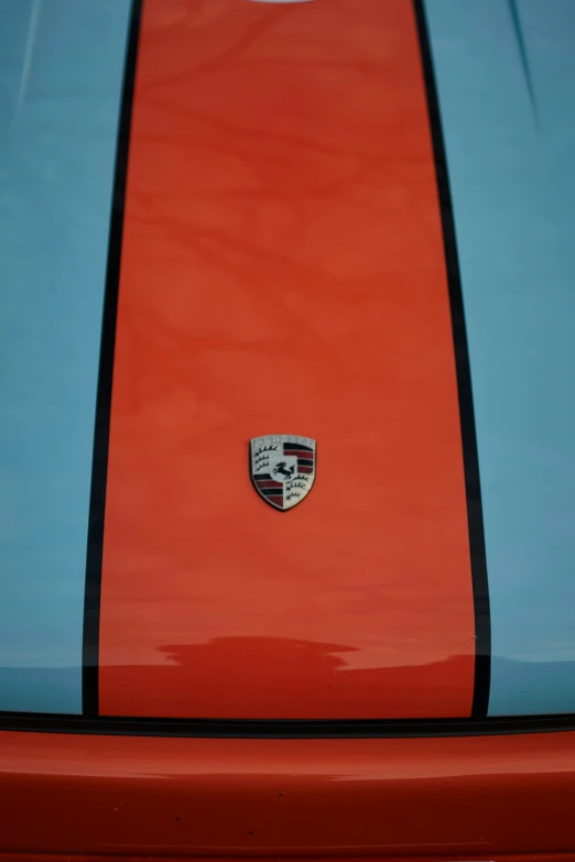 close up of the logo on the hood of a colorful sports car