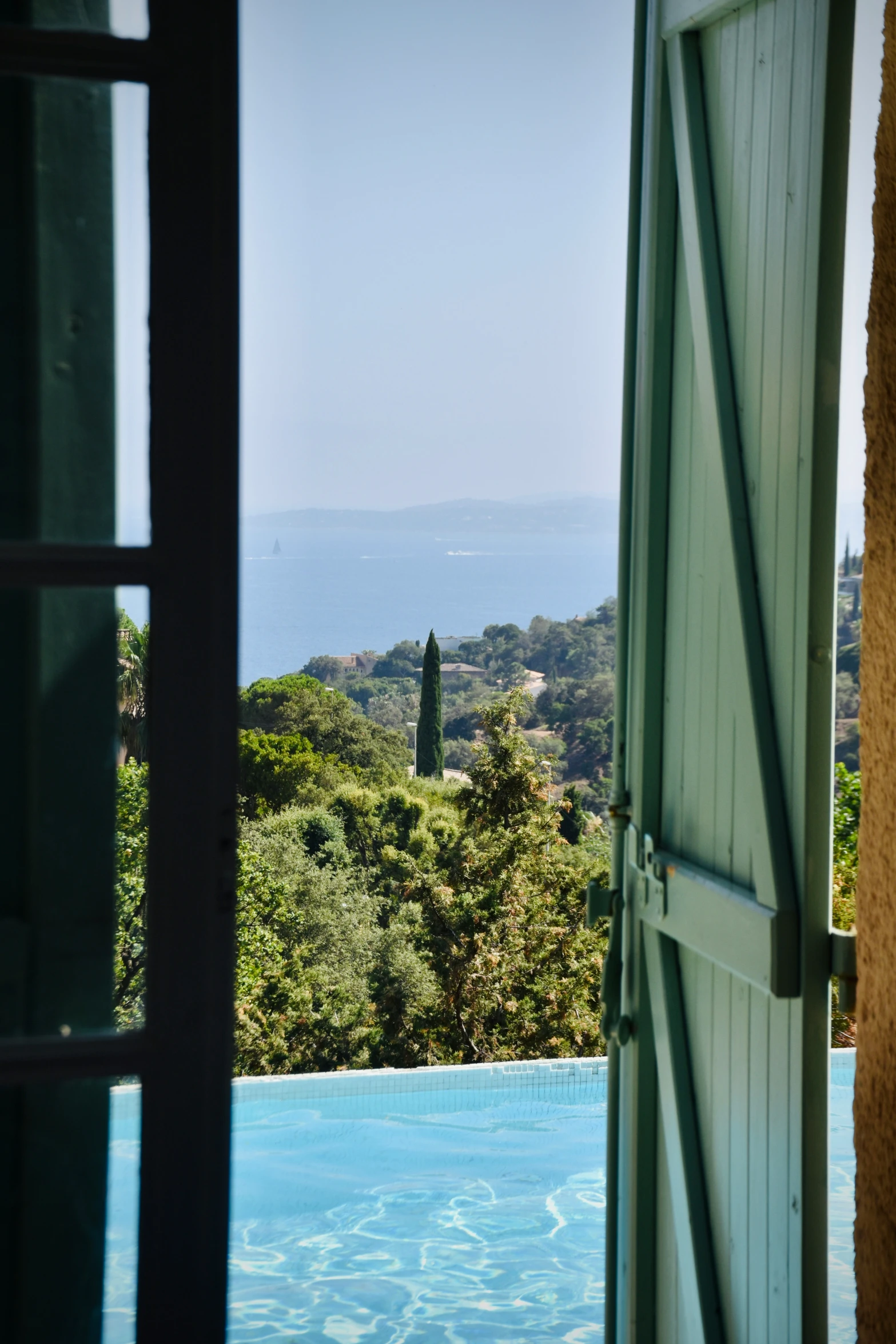 a pool with the view looking out on the water