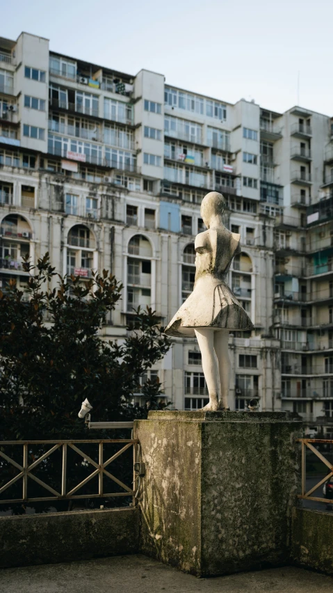 a sculpture in front of a large building