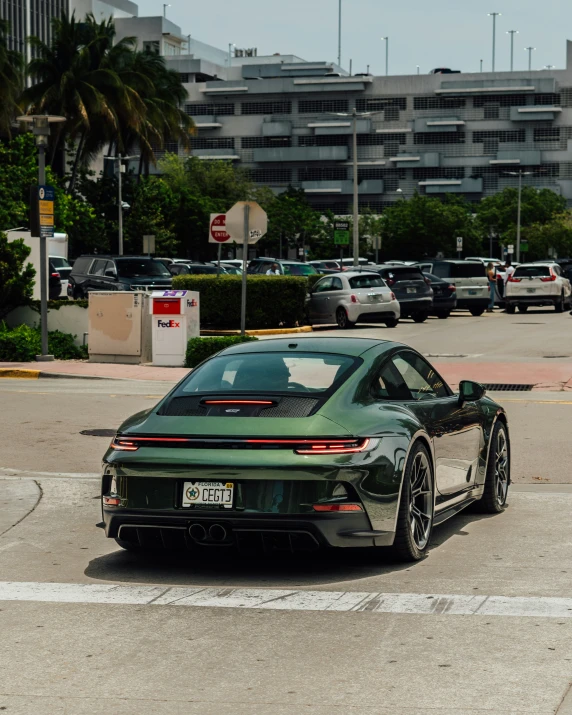 a very green car parked in front of a parking meter