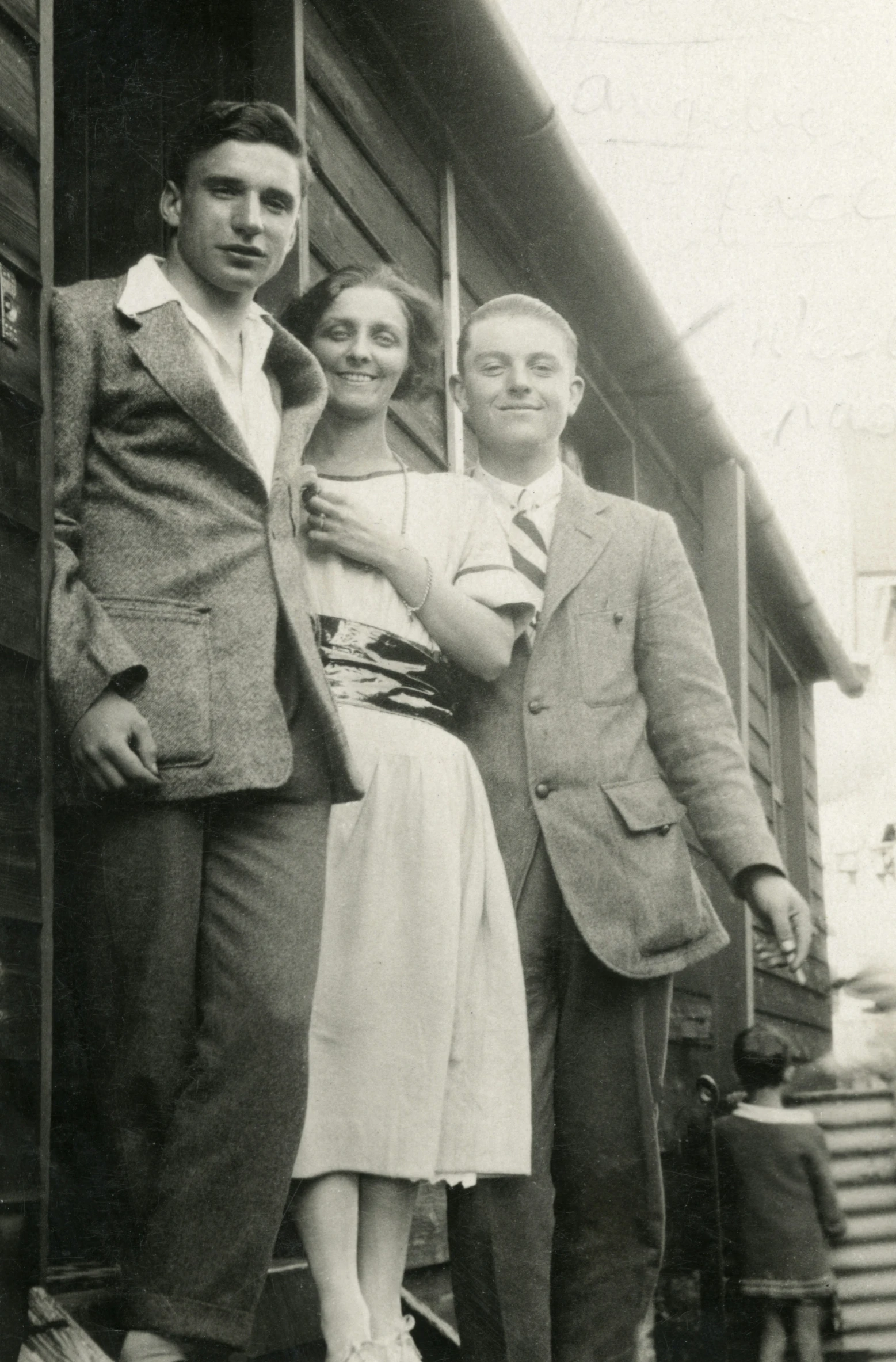 the family poses for a po on the steps of a cabin