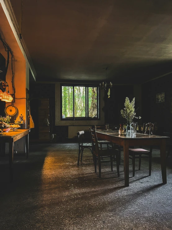 a dining room with dark walls and long table