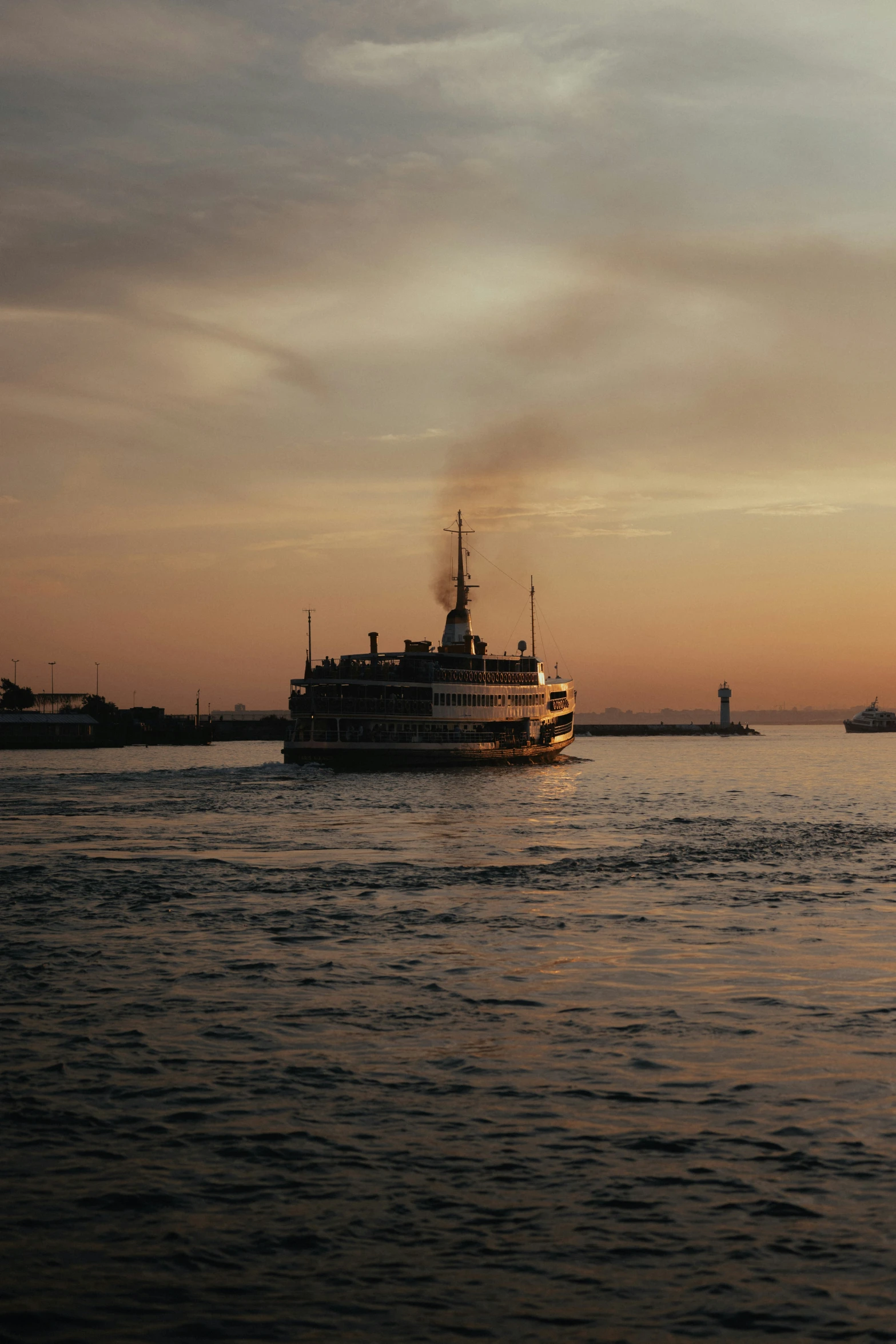 a large ship moving through the water during sunset