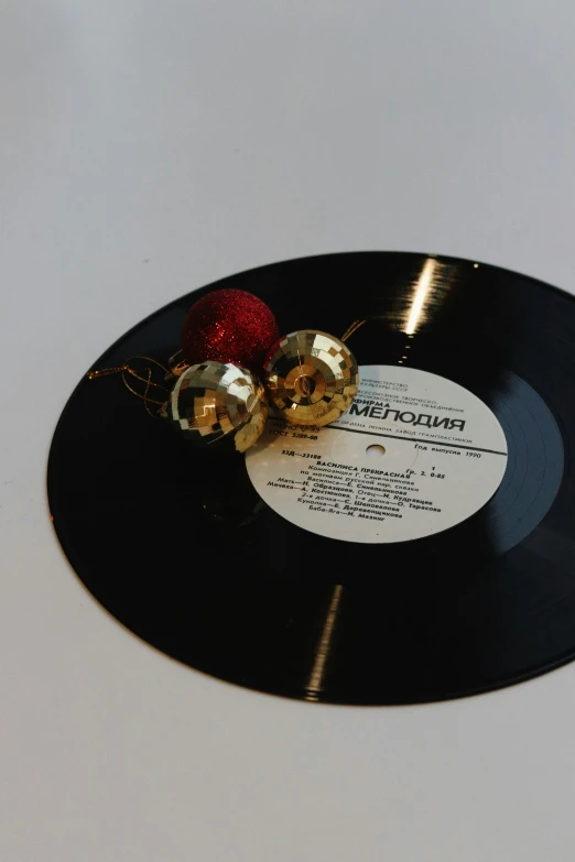 a record with two shiny red ornament on it