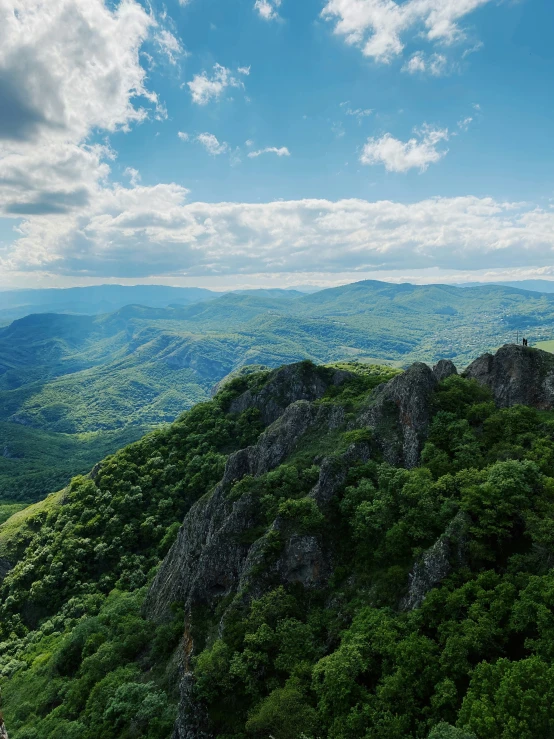 the view from the top of a mountain shows trees and mountains