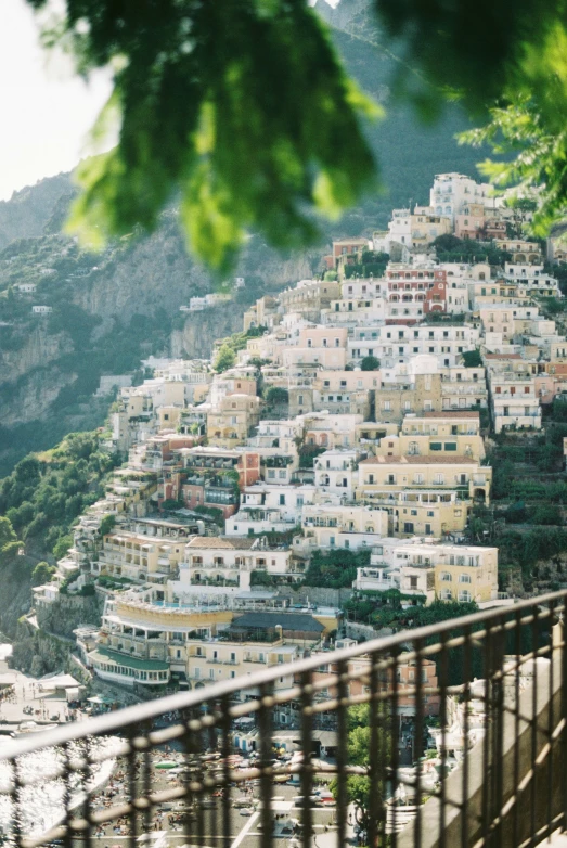 view from the top of a hill on a city with lots of white buildings