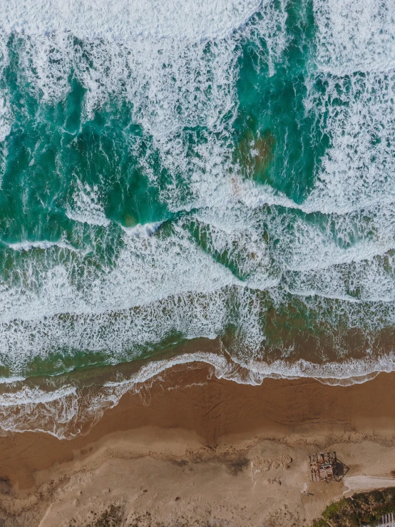 the waves rolled over the beach on the sand