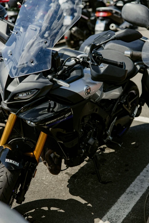 motorcycles parked in a row on the side of a road