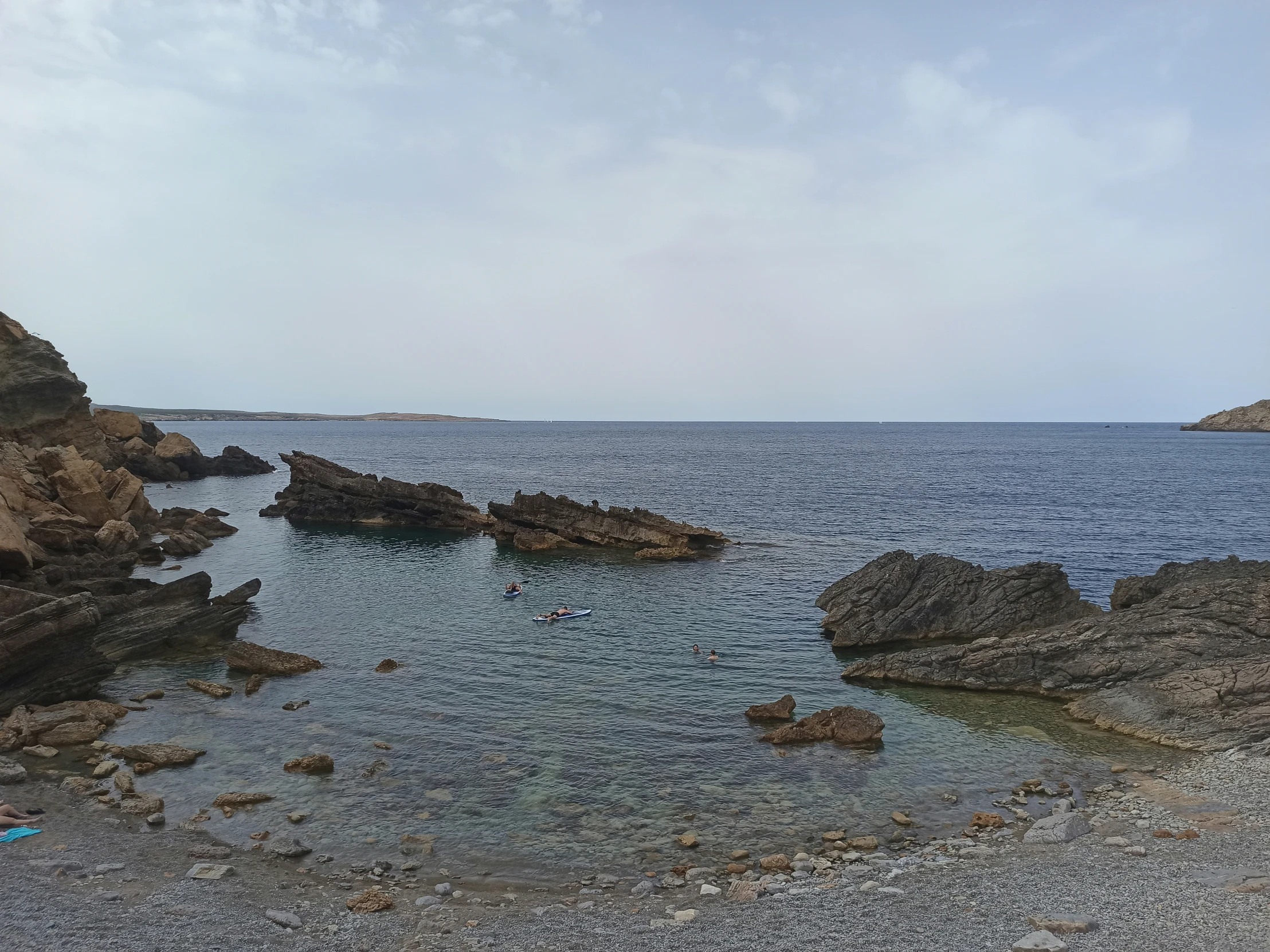 a body of water surrounded by rocky coast