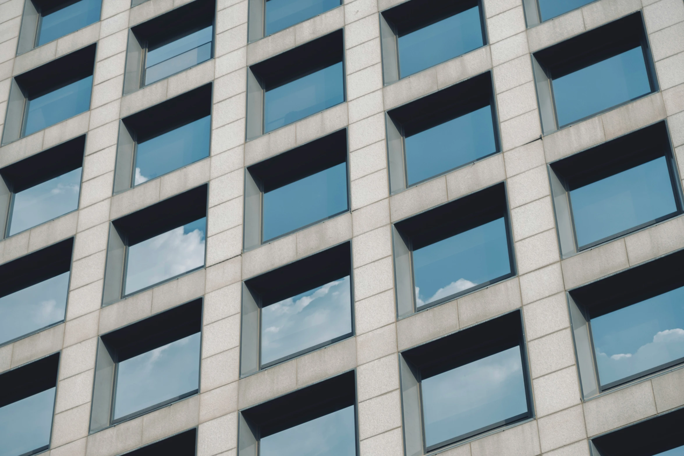 the windows in an office building look out to the sky