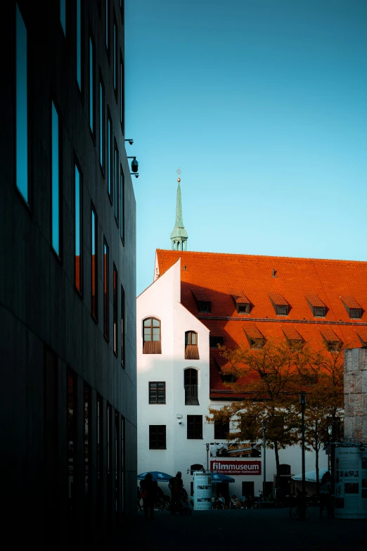 there is a building that has red roof and a clock