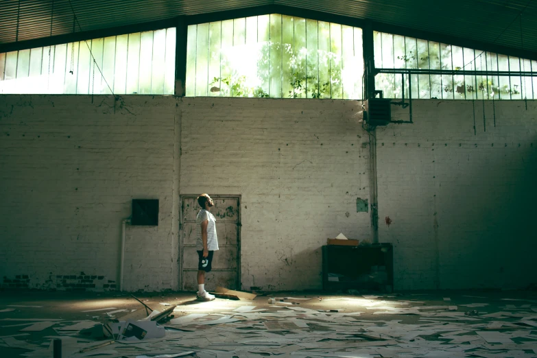 a man standing in an abandoned building near some door