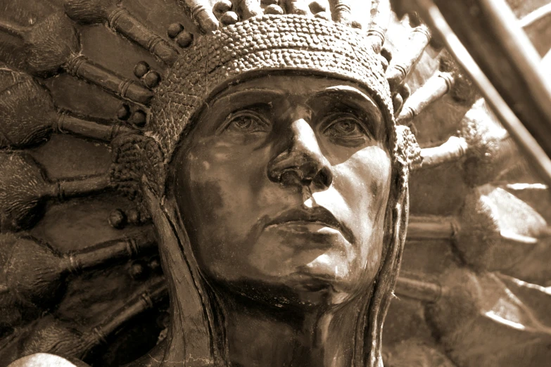 a statue wearing a head dress on top of a table