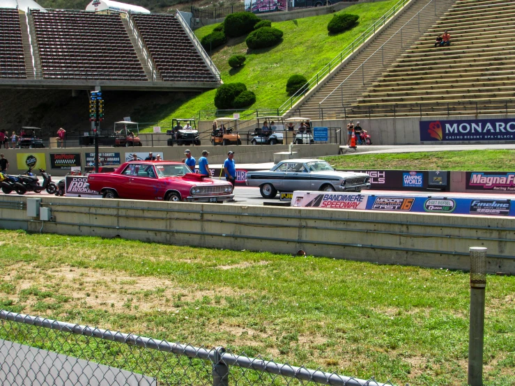 a race track full of cars near a stadium