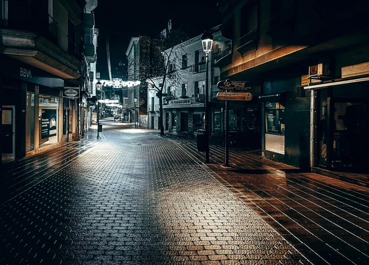 a dark city street is lit up with lights