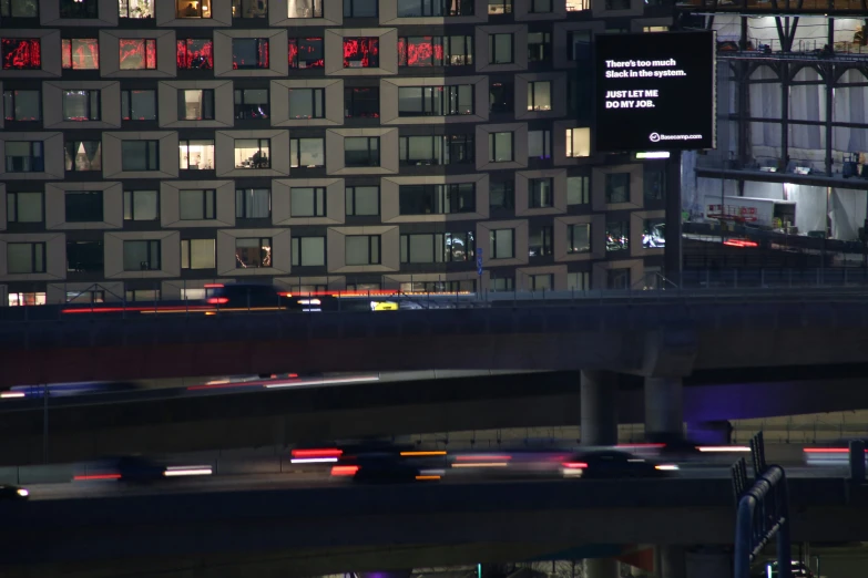 multiple cars move down a freeway at night