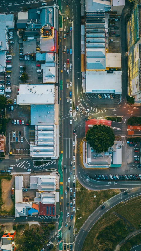 an overhead view of a street intersection with many cars