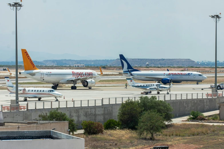 three airplanes at an airport parking on a run way