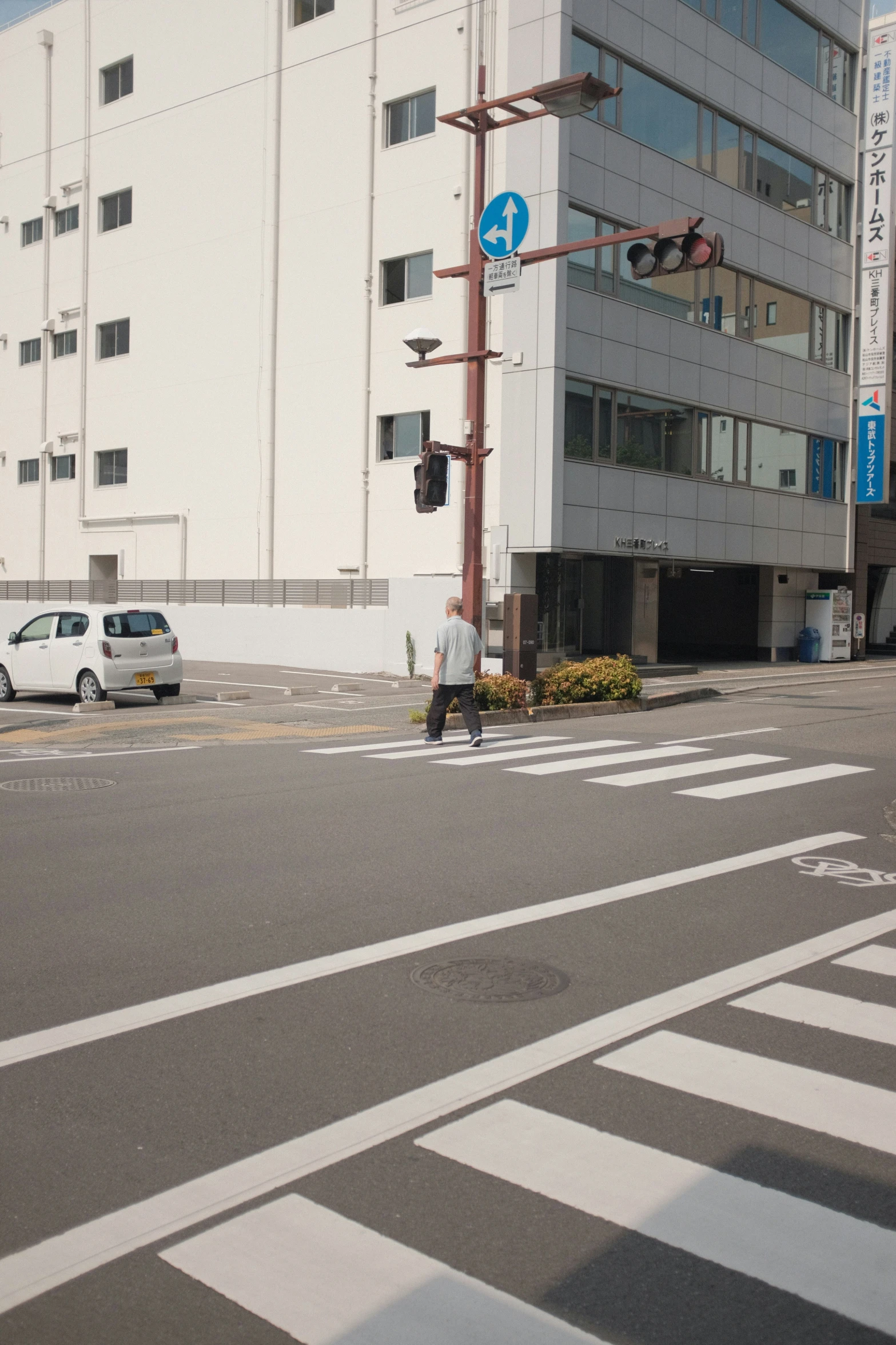 there are cars and people walking across the street