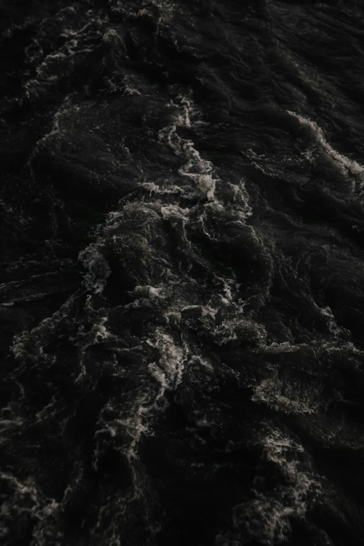 a black and white po of waves coming into the ocean