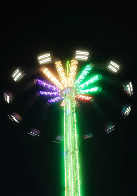 an illuminated carnival ride at night with lights on it