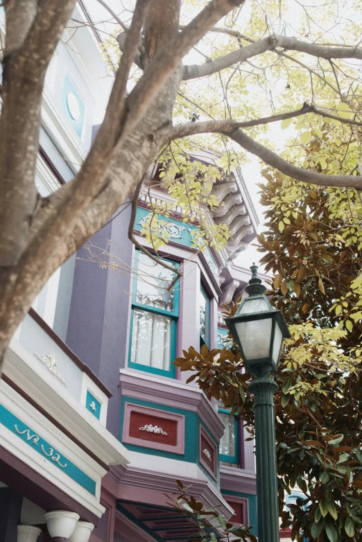 a lamp post outside an establishment with colorful buildings in the background