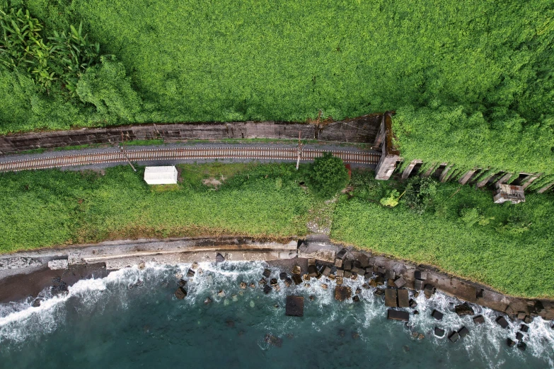 aerial view of grassy landscape with stairs near ocean