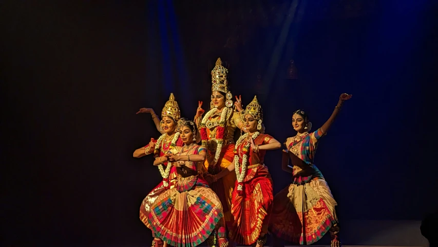 three female dancers performing a show with each other