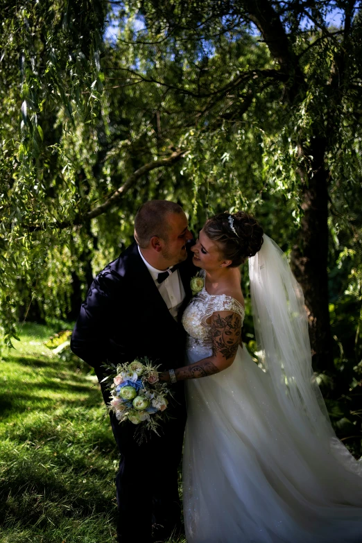 a bride and groom are posing in the sun