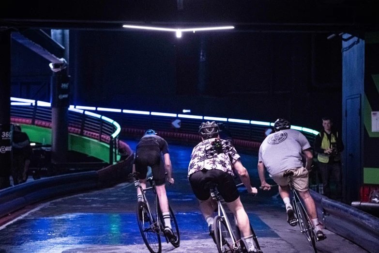 a group of people riding bicycles on a road