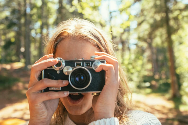 a woman with long hair is taking pictures with her camera