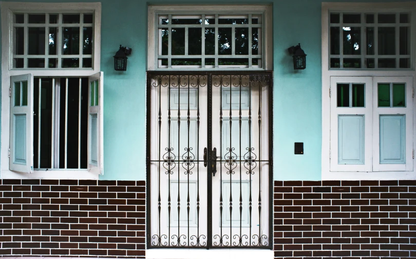 a pair of double doors is attached to the front of a house