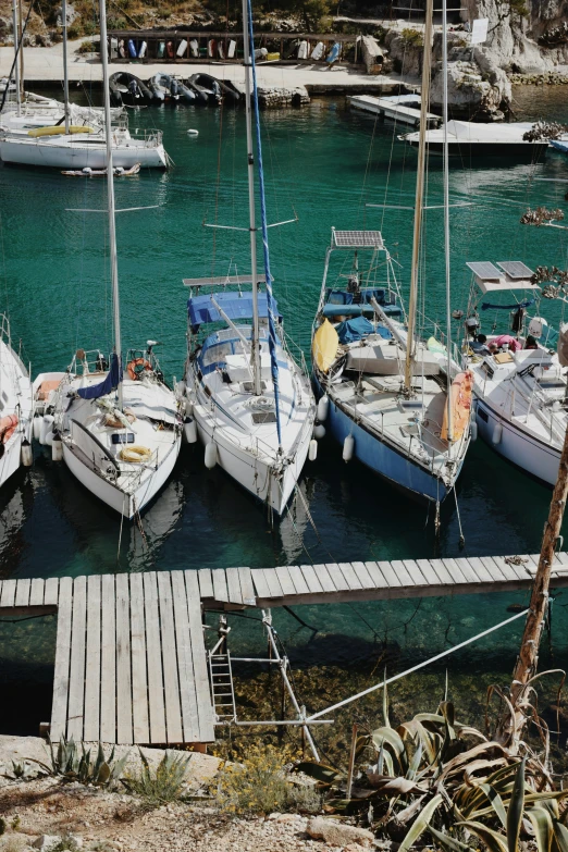 many different small boats docked at the dock