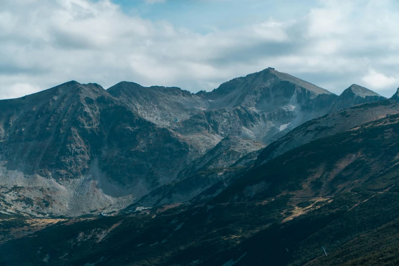 a rocky mountain area under a blue sky