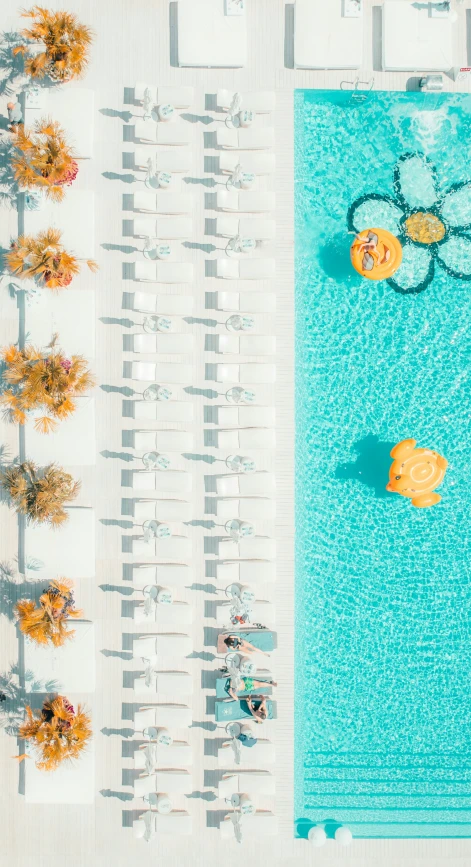 three people float through the water in a pool