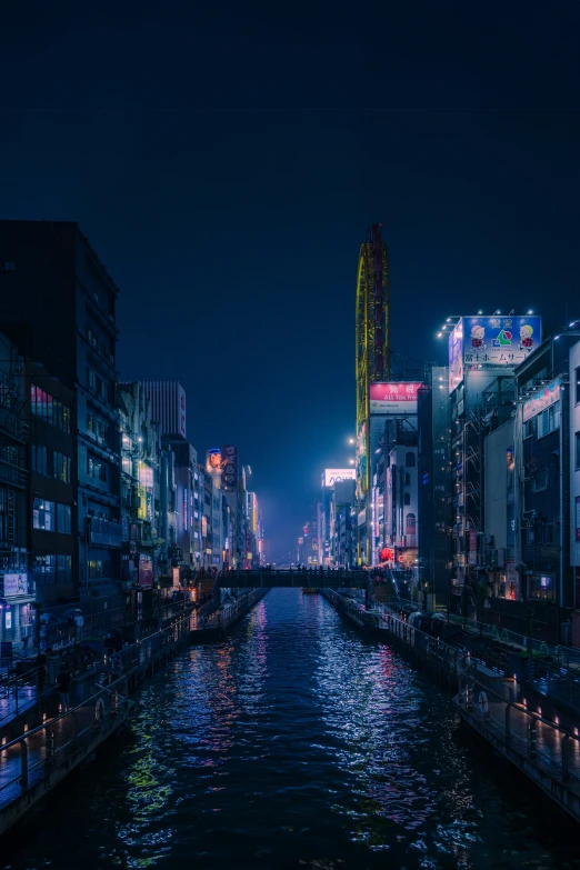 a river at night and the city lights reflected in the water